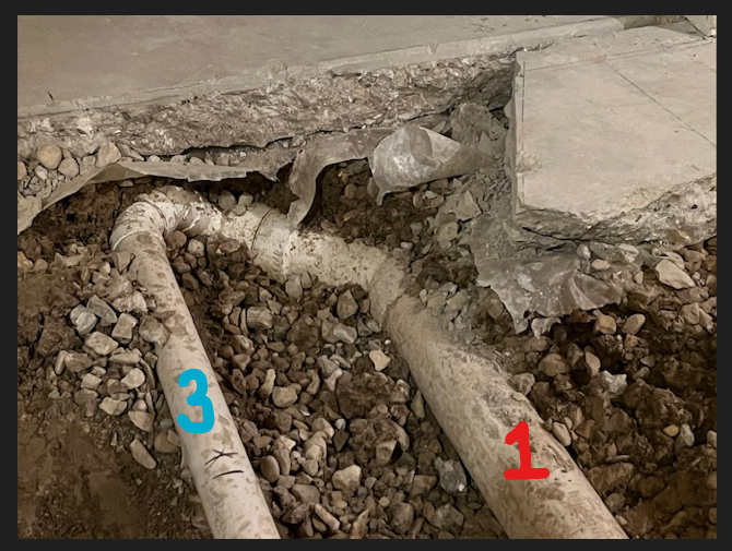 Basement bathroom picture vent pipe connecting to drain pipe.png